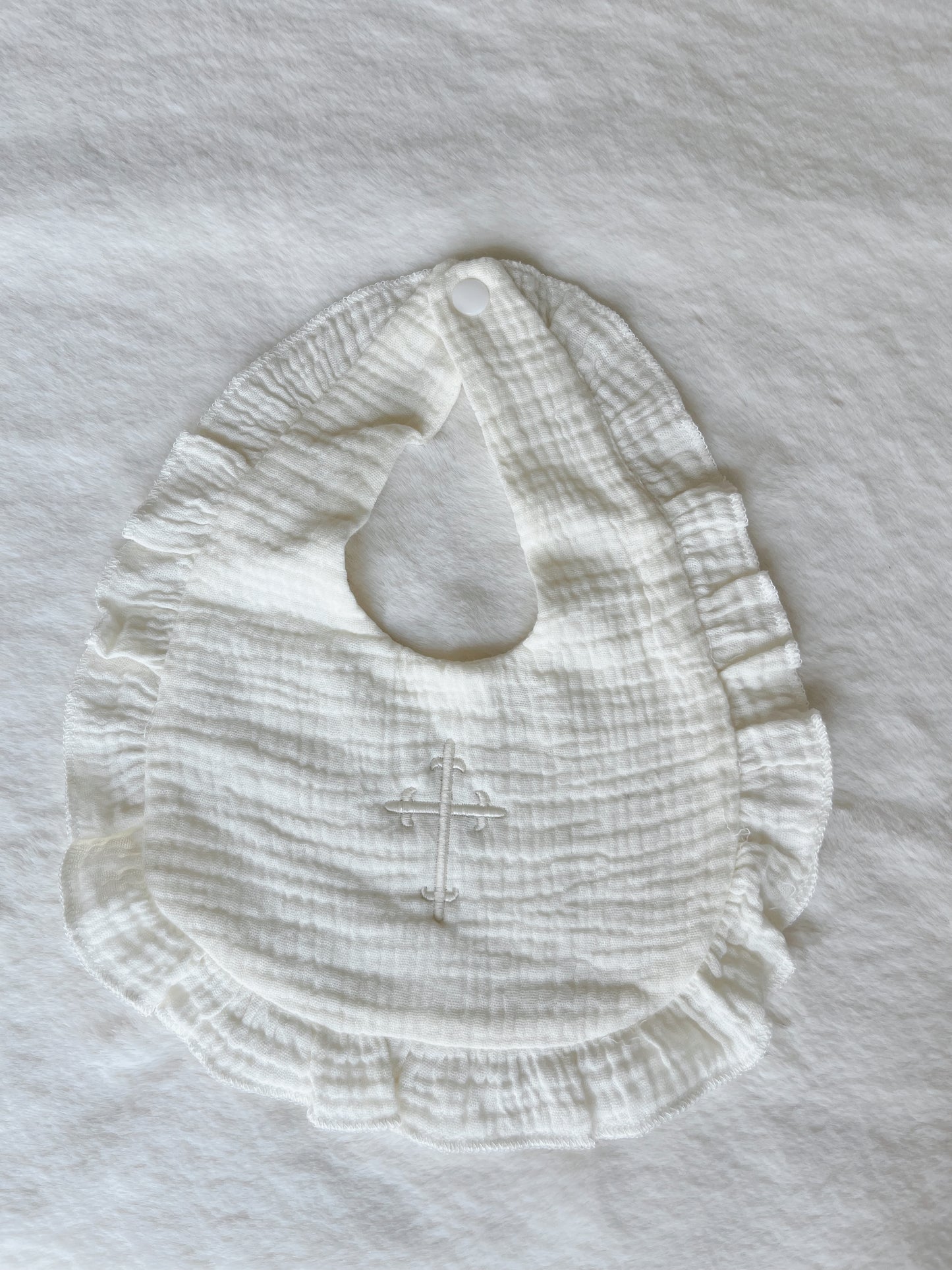Ruffle Bib with Embroidered Cross